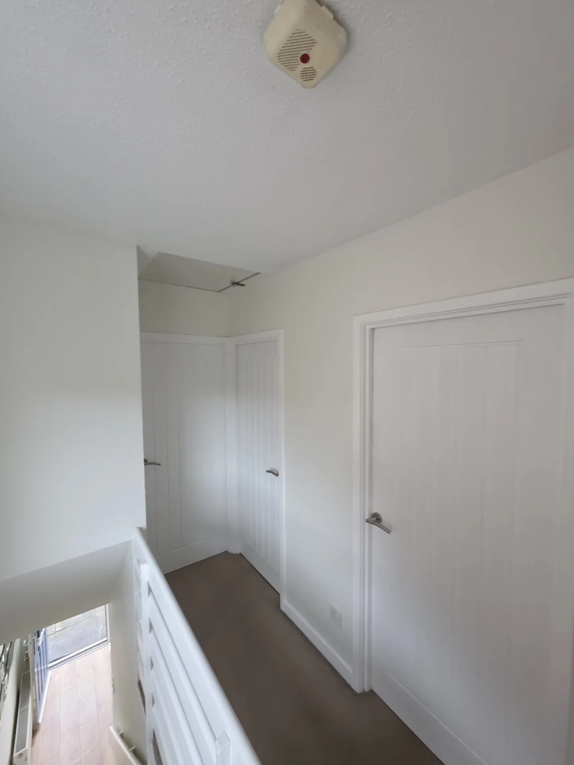 Freshly painted landing and white interior woodwork from a completed Fix and Finish decorating job